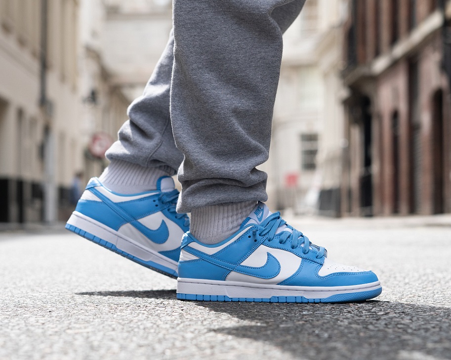 man with baby blue nike low dunks on the street