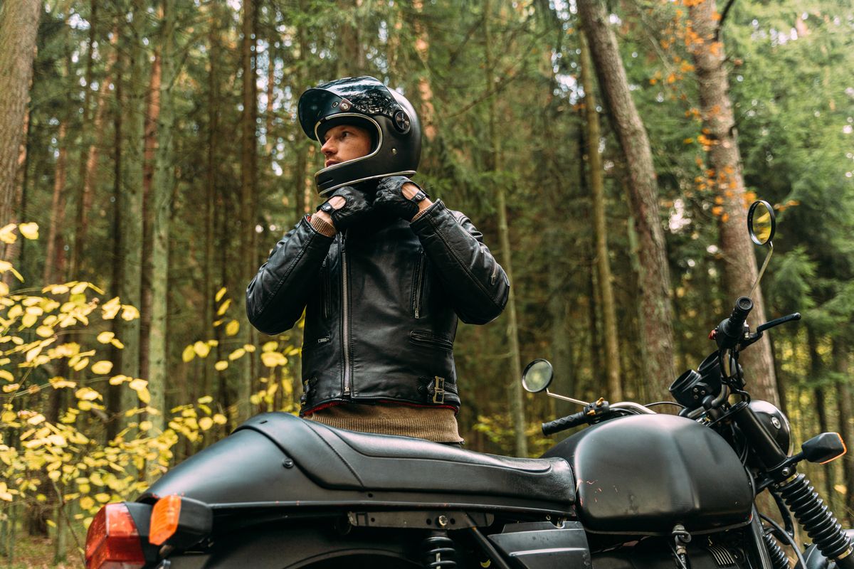 man getting ready for driving with motorcycle